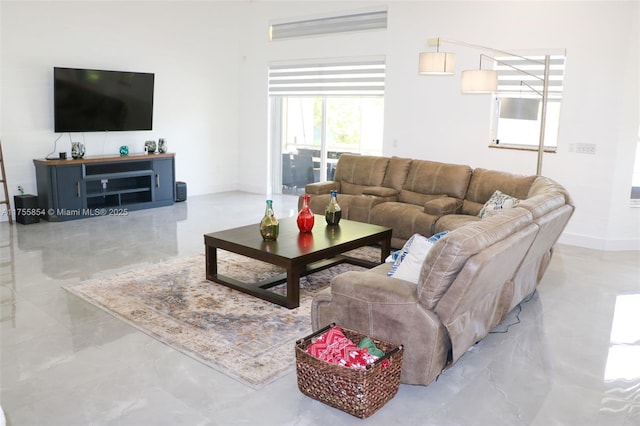 living area featuring marble finish floor and baseboards