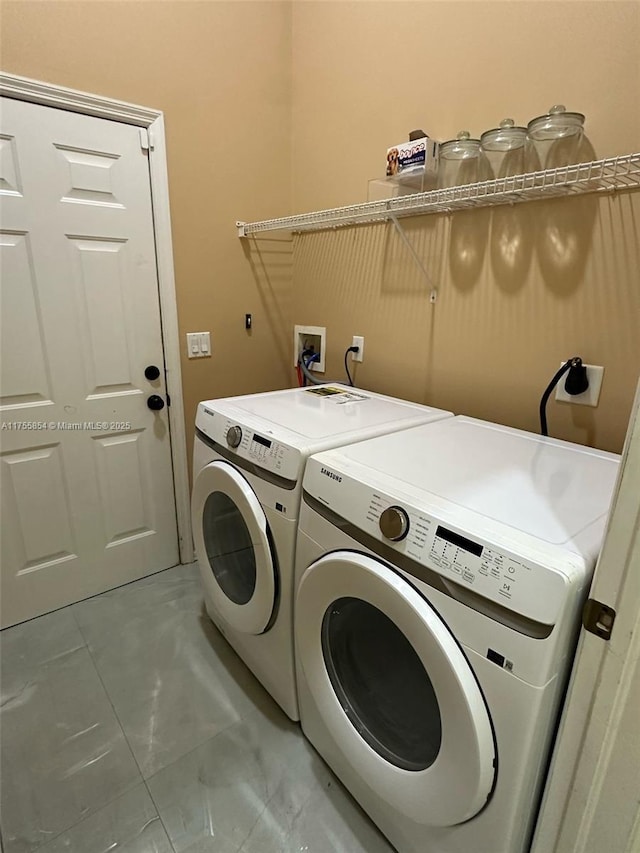 clothes washing area with laundry area and washer and clothes dryer