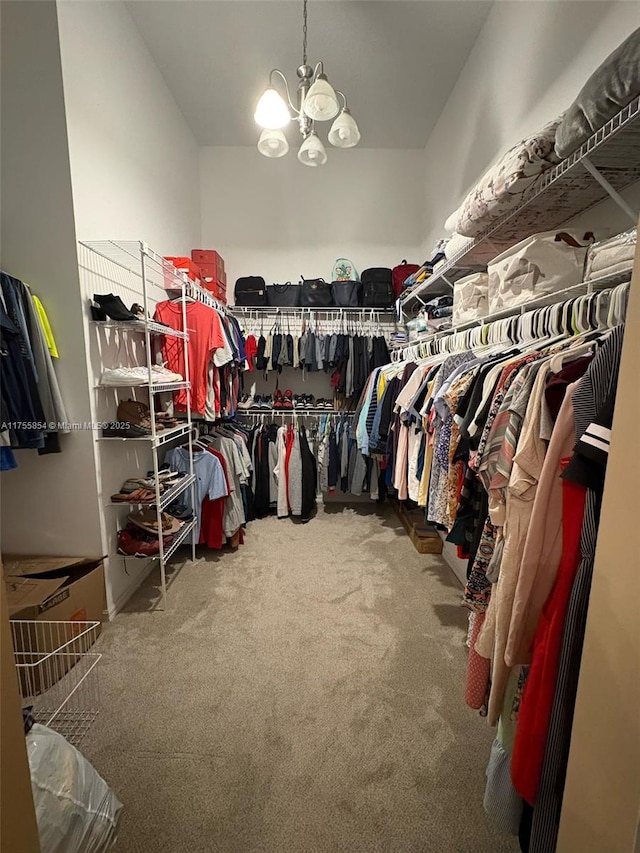 spacious closet featuring carpet and a chandelier