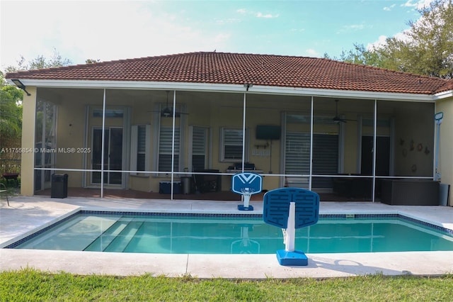 back of house featuring a sunroom, ceiling fan, a patio area, and an outdoor pool