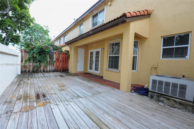 wooden deck featuring fence, central AC, and french doors