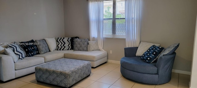 tiled living room featuring baseboards