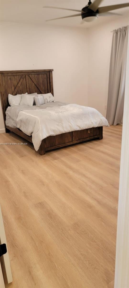 bedroom with wood finished floors and a ceiling fan