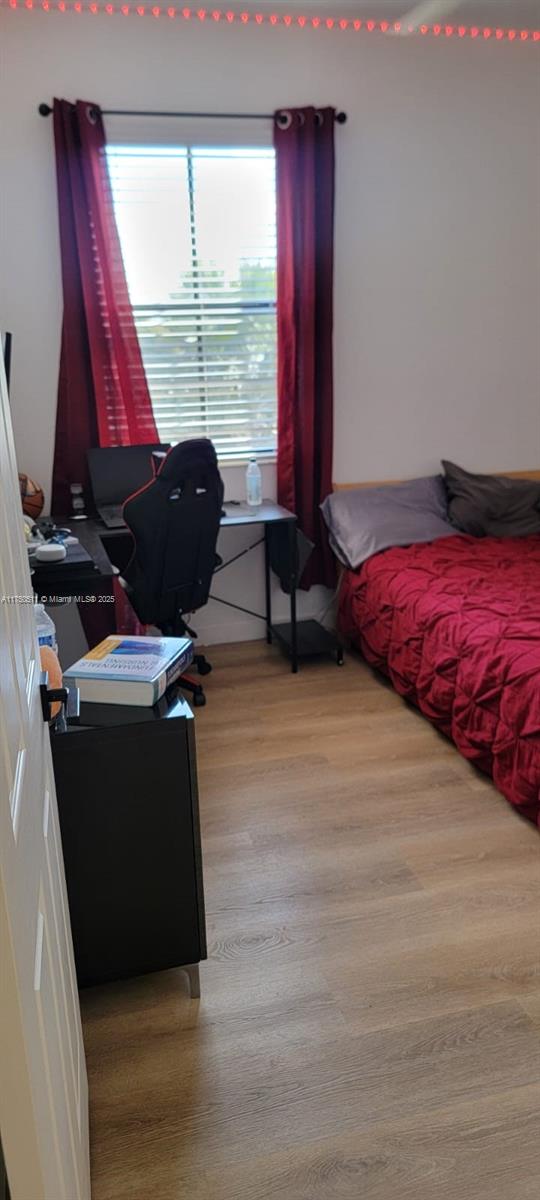 bedroom featuring light wood-style flooring