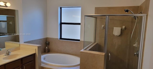 full bath featuring a stall shower, vanity, and a bath