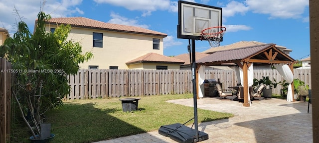 view of yard featuring a patio, a gazebo, and a fenced backyard