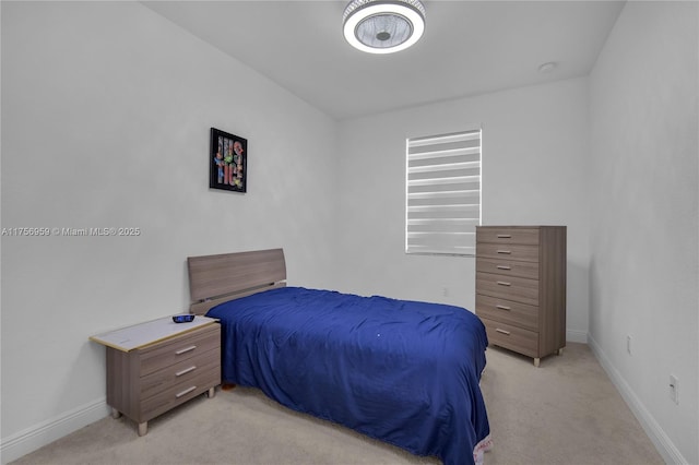 bedroom with baseboards and light colored carpet