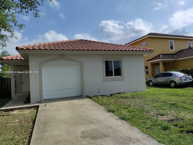 view of side of property with stucco siding, a lawn, a garage, driveway, and a tiled roof