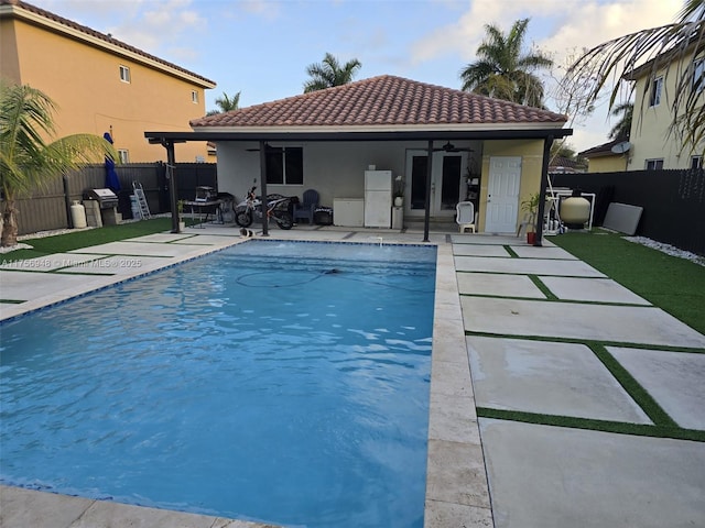 view of swimming pool with a fenced backyard, a grill, an outdoor structure, a fenced in pool, and a patio area