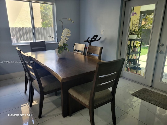 dining area featuring marble finish floor