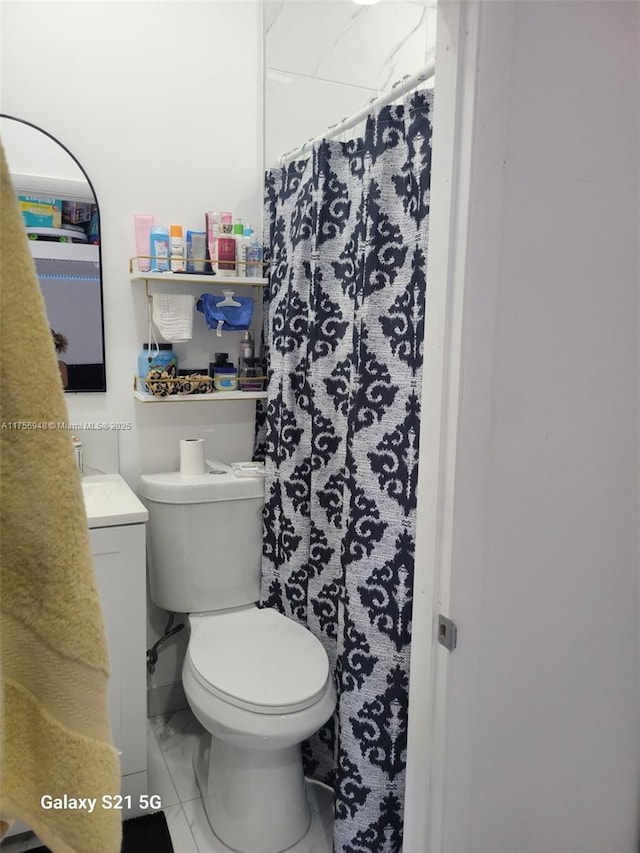 full bathroom with marble finish floor, curtained shower, toilet, and vanity