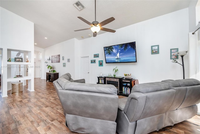 living room with visible vents, lofted ceiling, recessed lighting, a ceiling fan, and light wood finished floors