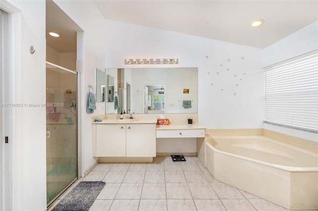 bathroom featuring a garden tub, a wealth of natural light, a shower stall, vanity, and tile patterned floors