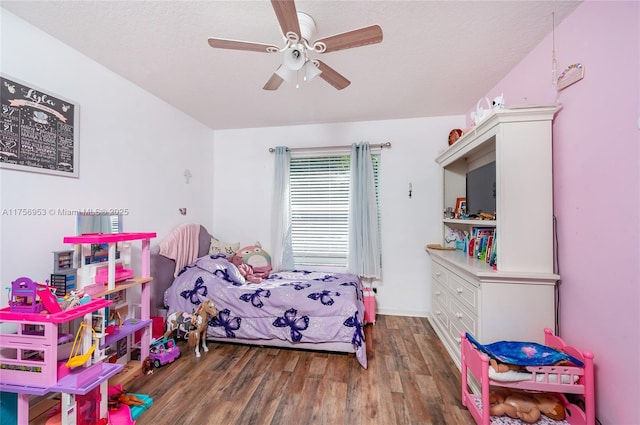 bedroom with a textured ceiling, a ceiling fan, and wood finished floors