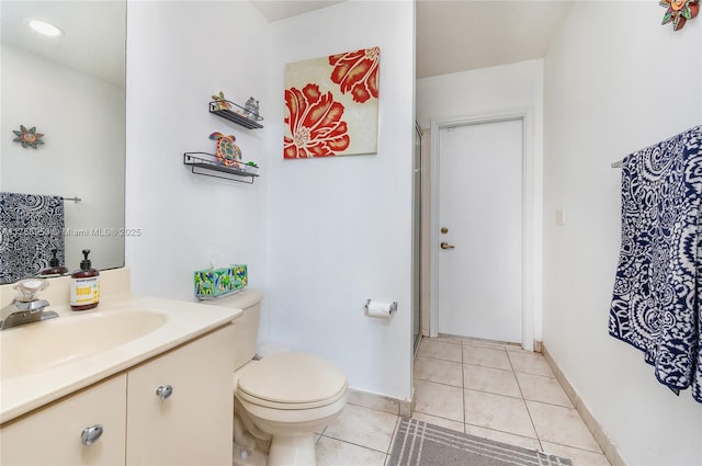bathroom with vanity, tile patterned flooring, baseboards, and toilet