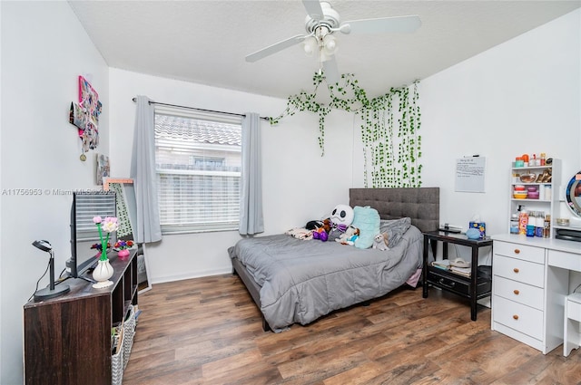 bedroom featuring baseboards, a ceiling fan, and wood finished floors