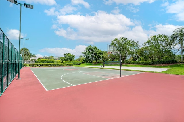 view of basketball court with community basketball court and fence