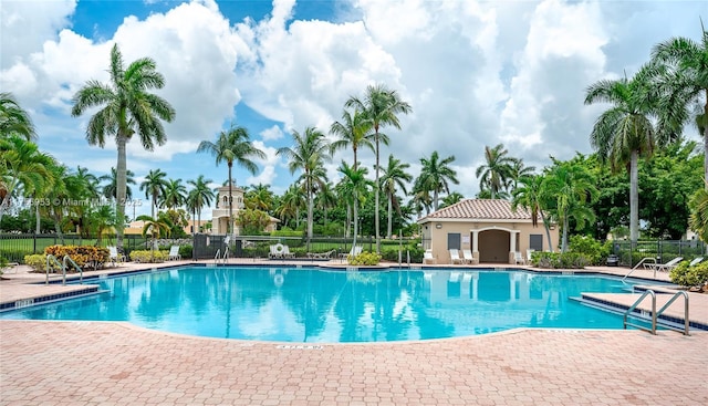 pool with fence and a patio area