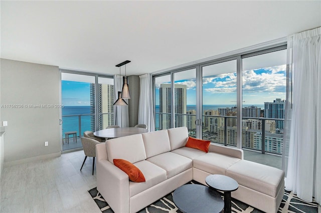 living room with a view of city, a healthy amount of sunlight, baseboards, and floor to ceiling windows