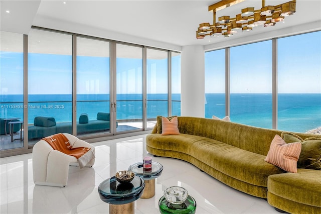 tiled living area with a wall of windows and a water view