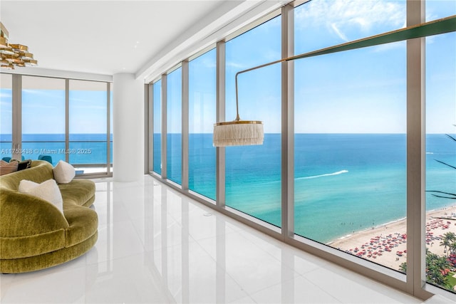 sunroom featuring a water view