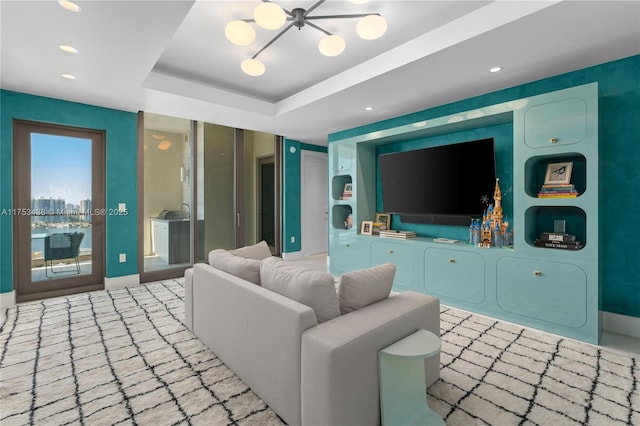 living room featuring a tray ceiling, baseboards, and recessed lighting