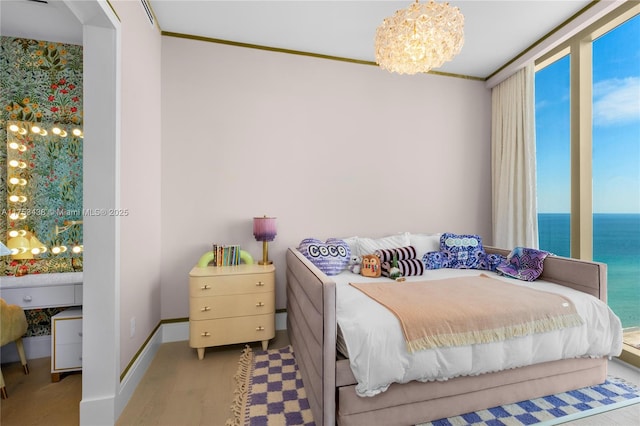 bedroom with baseboards, wood finished floors, a water view, crown molding, and a notable chandelier