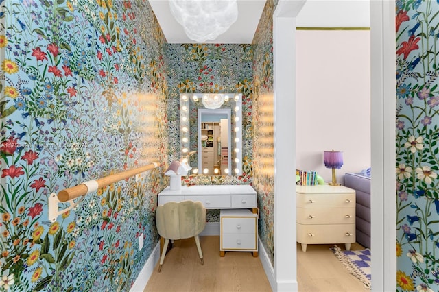 bathroom featuring wallpapered walls and baseboards