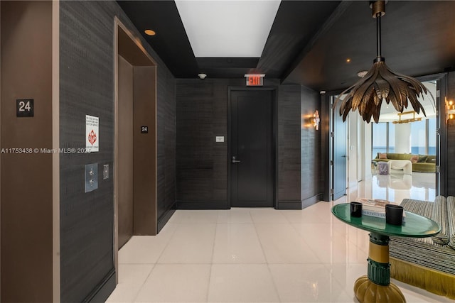 hall featuring elevator and tile patterned floors