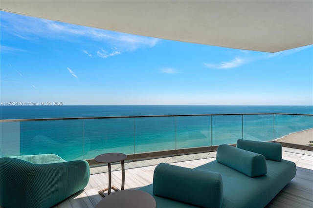 balcony with an outdoor hangout area and a water view