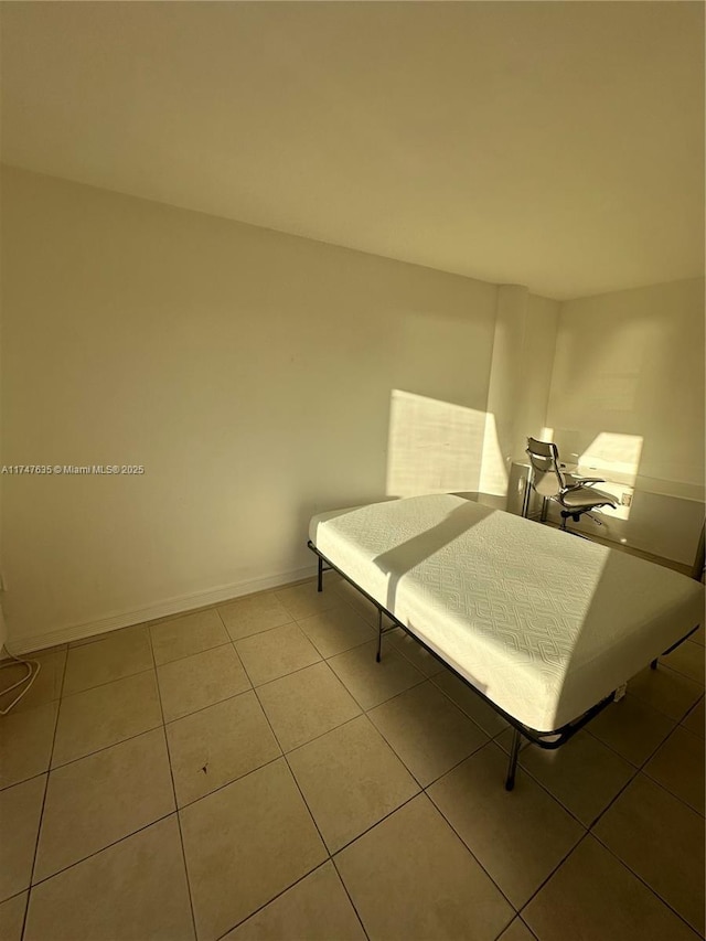 tiled bedroom with baseboards