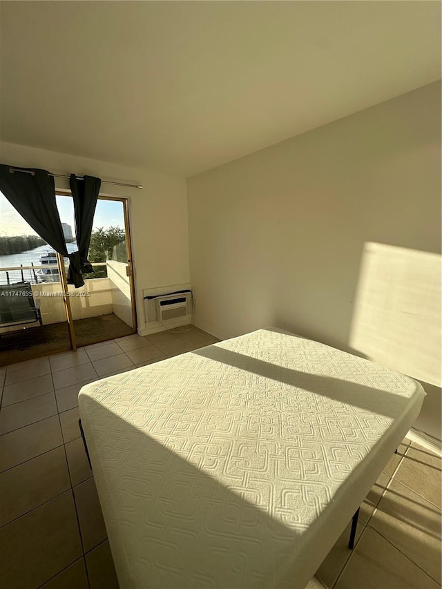 tiled bedroom with a wall mounted air conditioner