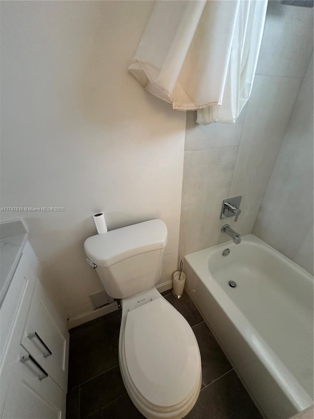 bathroom with baseboards, toilet, and tile patterned floors