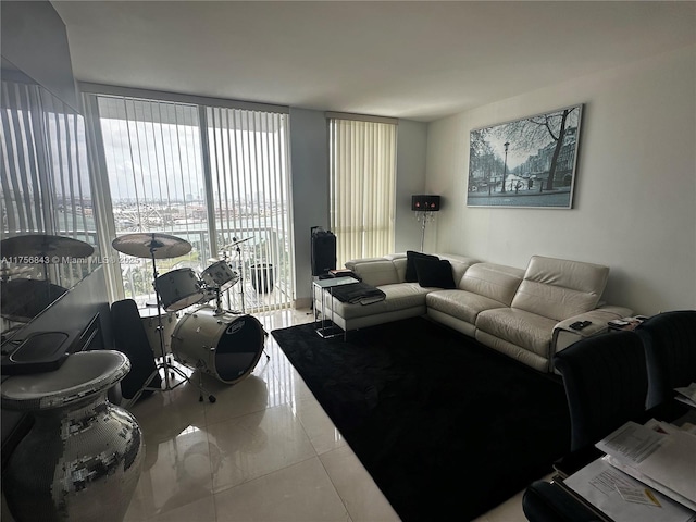 living room with floor to ceiling windows and tile patterned floors