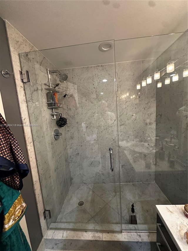 full bath with a shower stall and vanity