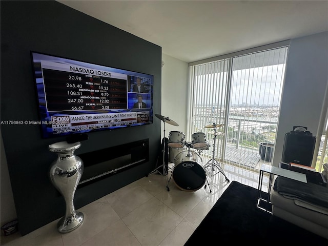 living area featuring tile patterned flooring and a wall of windows