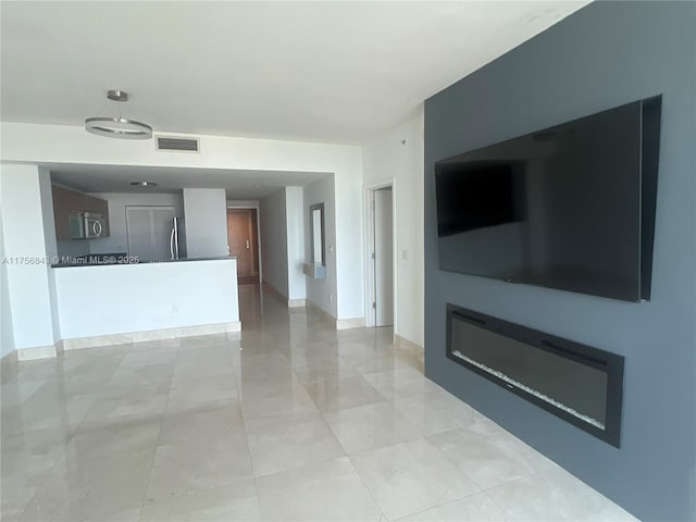 unfurnished living room featuring visible vents
