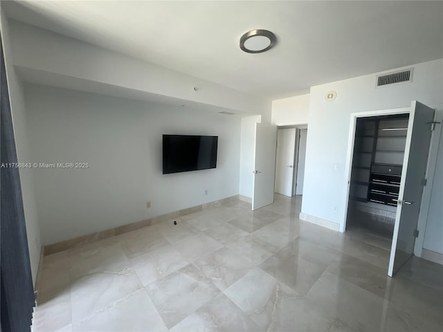unfurnished bedroom featuring baseboards and visible vents