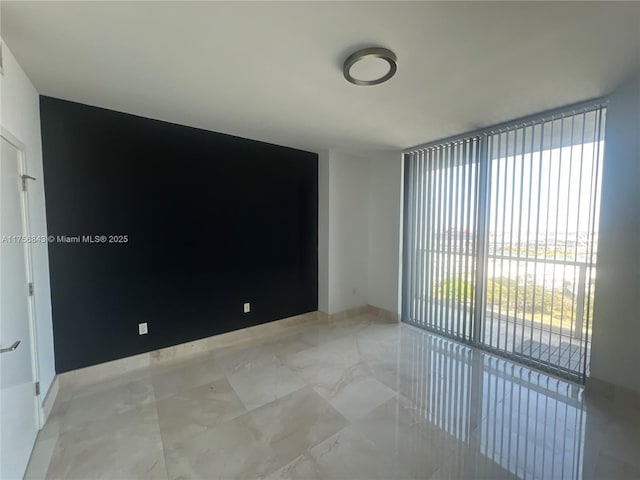 spare room with marble finish floor