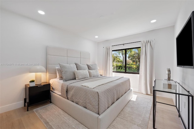 bedroom with recessed lighting, light wood-style flooring, and baseboards