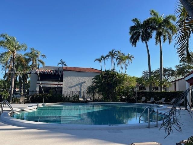 pool featuring a patio area and fence