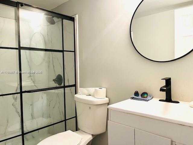 20220 NE 3rd Ct Unit 4, Miami, FL 33179 - full bathroom featuring vanity, a shower stall, and toilet