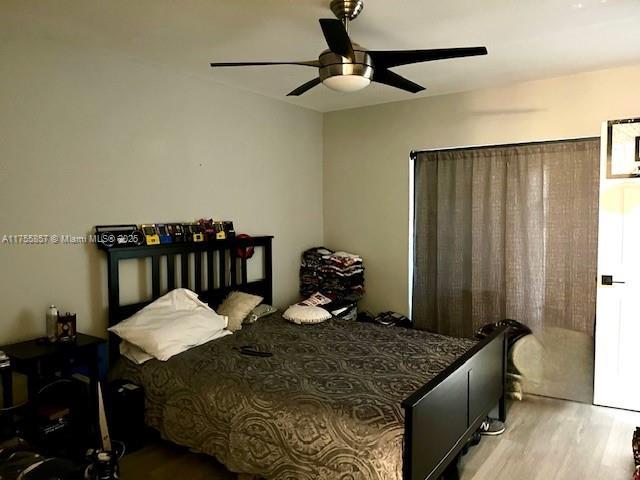 20220 NE 3rd Ct Unit 4, Miami, FL 33179 - bedroom featuring wood finished floors and ceiling fan