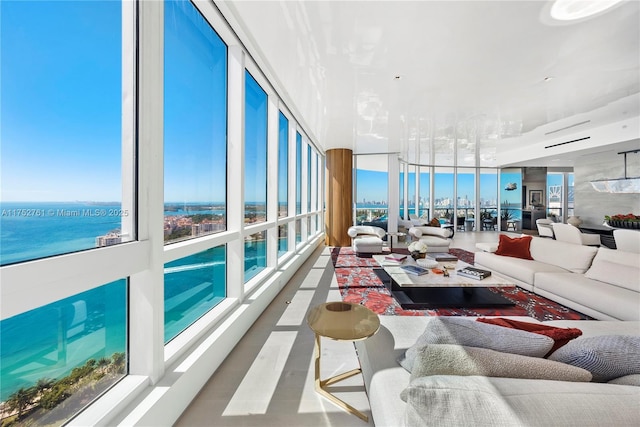 living room with expansive windows and a water view