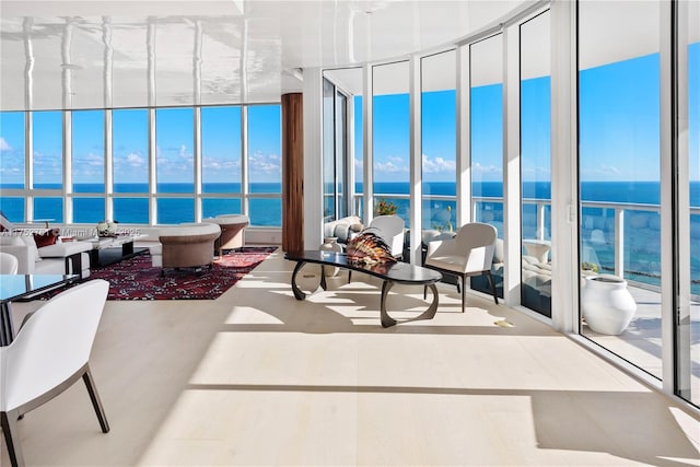 sunroom / solarium featuring a water view