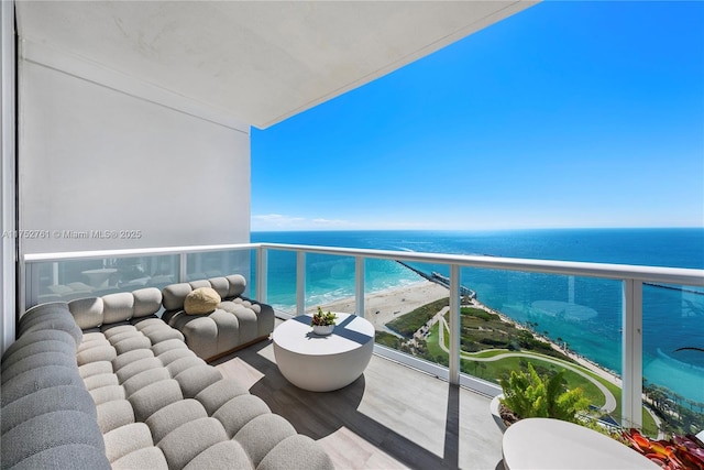 balcony featuring a water view and a view of the beach