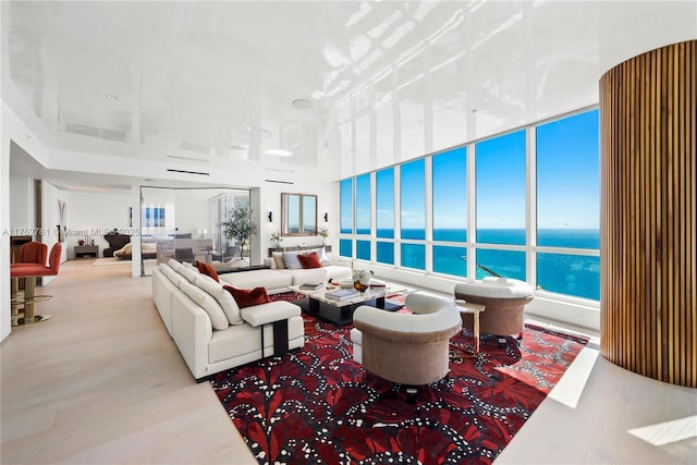 100 S Pointe Dr Unit 2803, Miami Beach, FL 33139 - living area with a water view, wood finished floors, and plenty of natural light