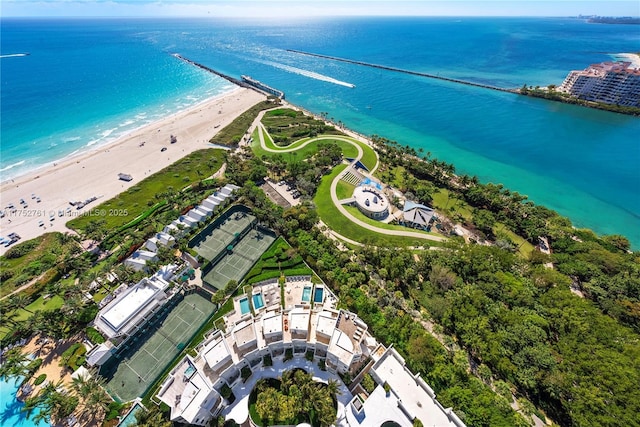 drone / aerial view featuring a water view and a view of the beach