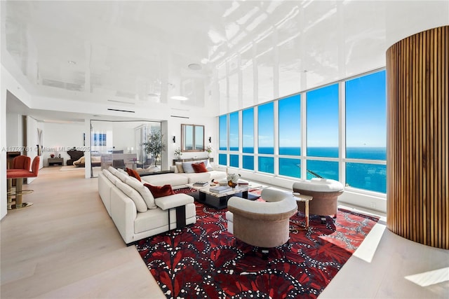 living area featuring a water view and wood finished floors