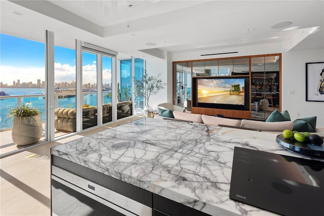 bedroom with access to outside, floor to ceiling windows, and a city view